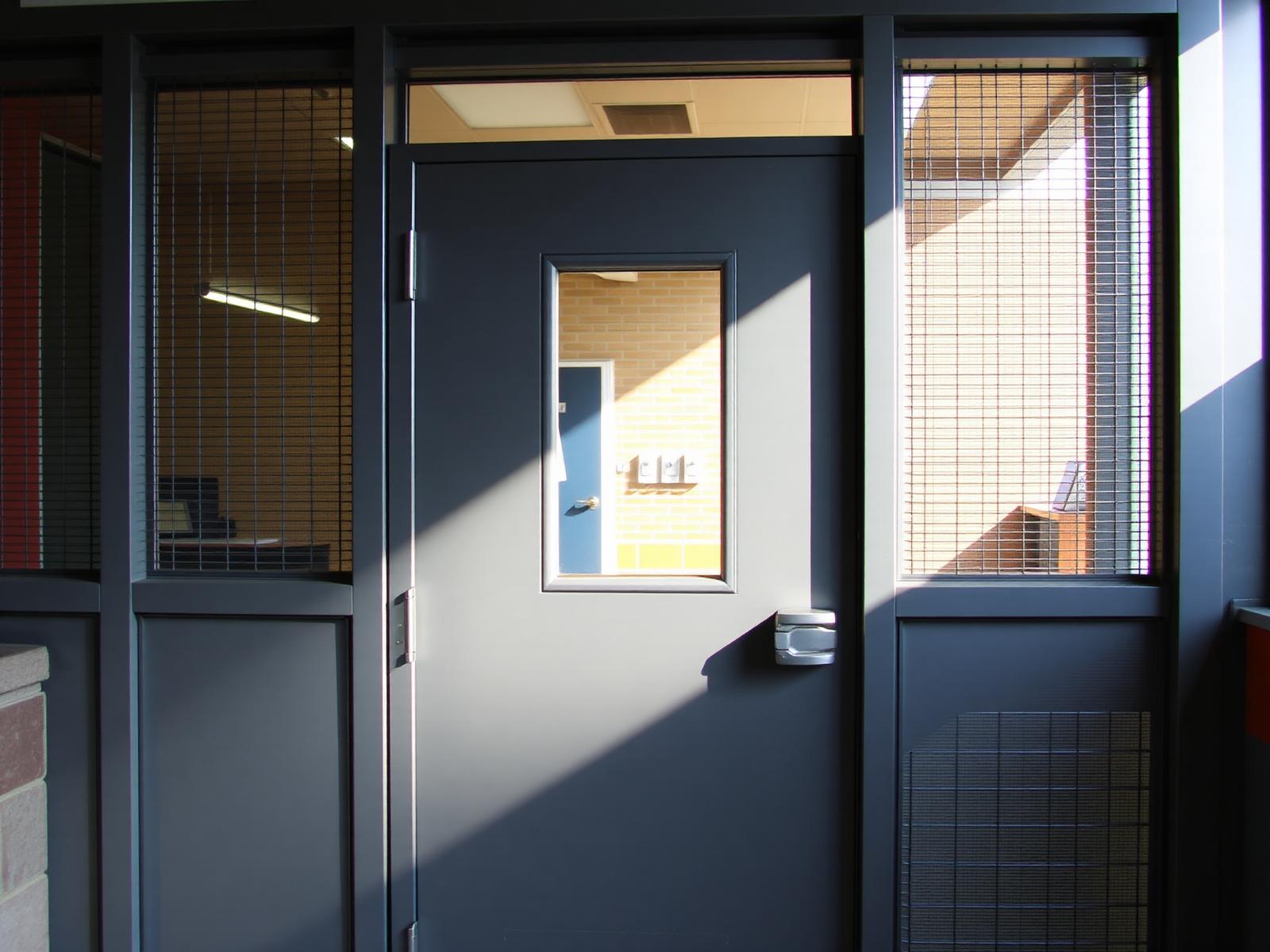Hollow metal door with vision lite in a commercial entrance